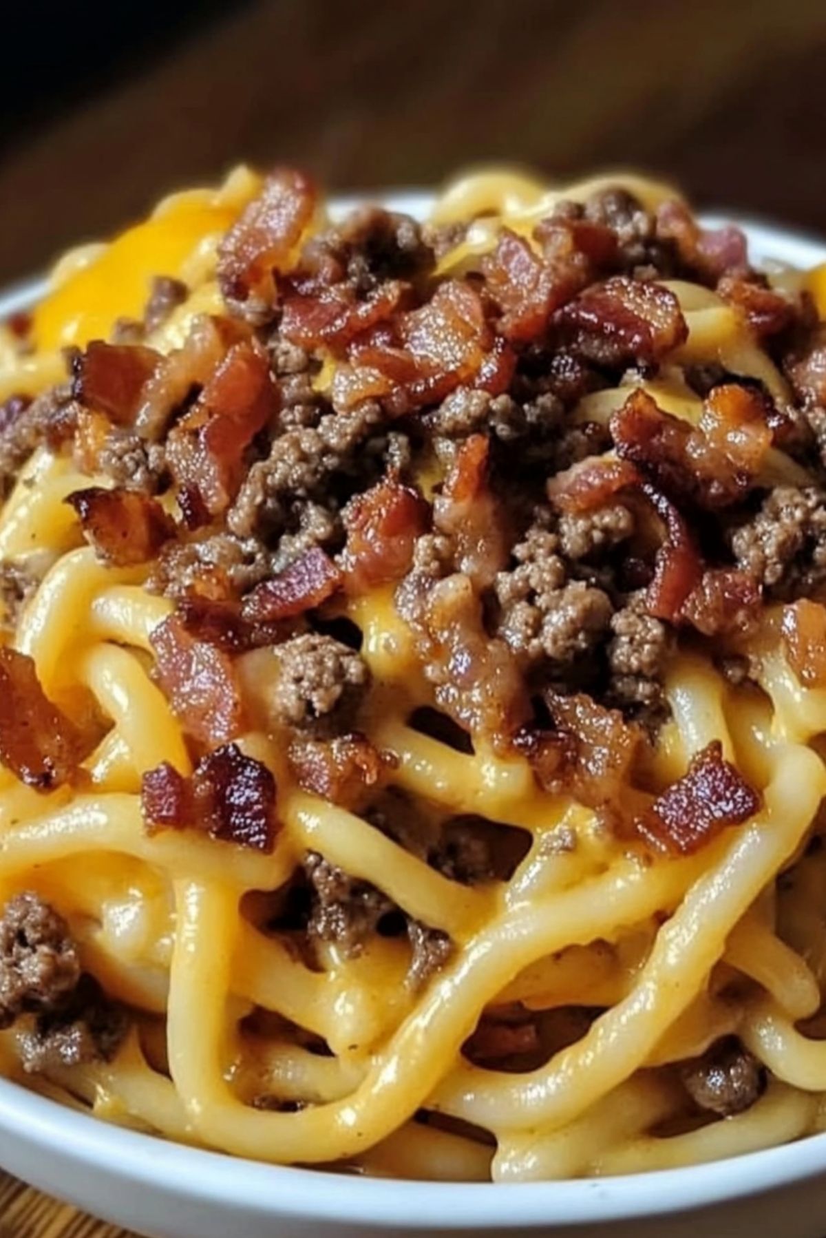 Loaded Bacon Cheeseburger Pasta – A Cheesy Comfort Food Favorite If you're craving something rich, cheesy, and full of flavor, this Loaded Bacon Cheeseburger Pasta is the ultimate comfort food. It’s packed with seasoned ground beef, crispy bacon, gooey cheese, and tender pasta—all the best parts of a classic bacon cheeseburger in a creamy, delicious pasta dish. Why You’ll Love This Recipe Cheesy and comforting – The perfect mix of gooey cheese and pasta. Packed with flavor – Bacon, beef, and seasonings make this dish irresistible. Quick and easy – Comes together in about 30 minutes. Family-friendly – A meal that both kids and adults will love. Ingredients Here’s a sneak peek at what you’ll need: Pasta (penne, rotini, or shells) Ground beef Bacon Onion Garlic Tomato sauce Worcestershire sauce Mustard Cheddar cheese Heavy cream Full list of ingredients and exact measurements are below. Directions 1. Cook the Pasta Boil your pasta in salted water until al dente. Drain and set aside. 2. Cook the Bacon In a large skillet, cook the bacon until crispy. Remove and drain on a paper towel-lined plate. 3. Brown the Beef Using the same skillet, cook the ground beef with onion and garlic until browned. Drain excess grease. 4. Build the Sauce Stir in tomato sauce, Worcestershire sauce, mustard, and seasonings. Let simmer for a few minutes. 5. Add the Cheese and Cream Lower the heat and stir in shredded cheddar and heavy cream until the sauce is smooth and cheesy. 6. Combine Everything Add the cooked pasta and crumbled bacon to the skillet, tossing to coat everything in the sauce. 7. Serve and Enjoy Top with extra cheese or fresh parsley before serving. Expert Tips and Tricks Use freshly shredded cheese – It melts better than pre-shredded. Don’t overcook the pasta – Keep it al dente so it holds up in the sauce. Crisp up the bacon well – Adds the perfect crunch to the dish. Recipe Variations and Possible Substitutions Swap ground beef for ground turkey for a lighter option. Add jalapeños or hot sauce for a spicy kick. Use different cheeses like Monterey Jack or Gouda for a unique flavor. Stir in some chopped pickles for extra burger-style tang. Serving and Pairing Suggestions This dish pairs well with a simple side salad, garlic bread, or roasted vegetables. A cold glass of iced tea or a classic soda makes a great drink choice! Storage and Reheating Tips Store leftovers in an airtight container in the fridge for up to 3 days. Reheat in a skillet over low heat with a splash of cream or milk to keep it creamy. Freeze for up to 2 months, thawing overnight before reheating. FAQs 1. Can I make this ahead of time? Yes! Prepare the dish and store it in the fridge. Reheat before serving. 2. Can I use a different type of pasta? Absolutely! Any short pasta shape works well. 3. How do I make this dish even cheesier? Add more shredded cheese or a little cream cheese for extra richness. 4. Can I make this dish spicy? Yes! Add crushed red pepper flakes or diced jalapeños for some heat. Conclusion Loaded Bacon Cheeseburger Pasta is a delicious mashup of two comfort food favorites. Whether you're cooking for family dinner or meal prepping for the week, this cheesy, satisfying dish is sure to be a hit!